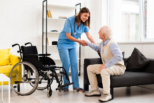 long-shot-nurse-helping-old-man-getting-up